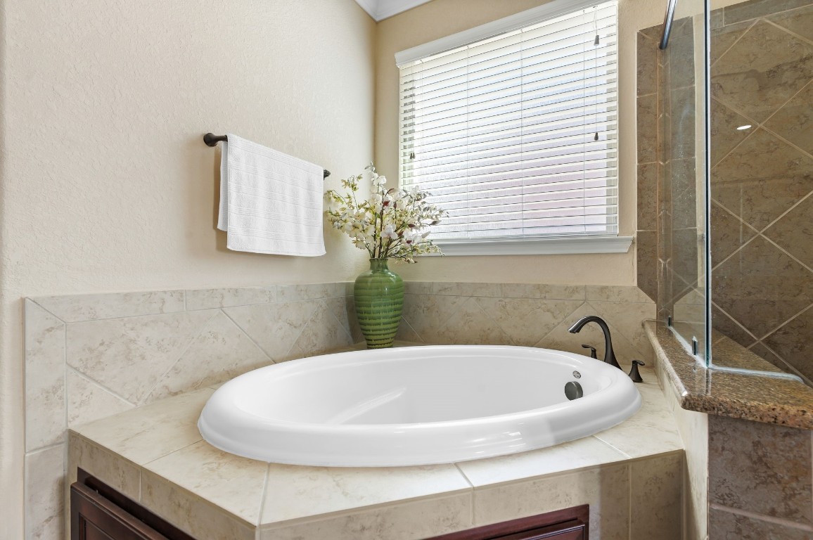 10 Waterfall Way The Woodlands, TX 77375 - Photo 26 of 45 a bathroom with a sink and a bathtub