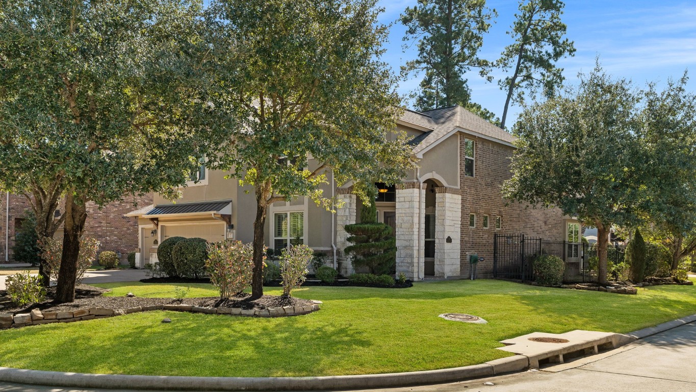 10 Waterfall Way The Woodlands, TX 77375 - Photo 3 of 45 front view of a house with a garden