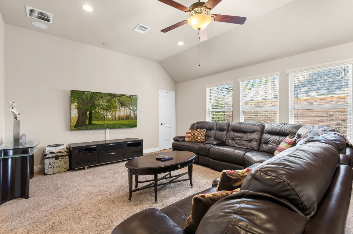 10 Waterfall Way The Woodlands, TX 77375 - Photo 31 of 45 a living room with furniture and a flat screen tv
