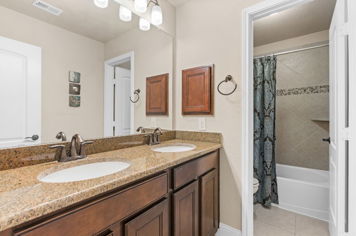10 Waterfall Way The Woodlands, TX 77375 - Photo 35 of 45 a bathroom with a granite countertop sink and a mirror