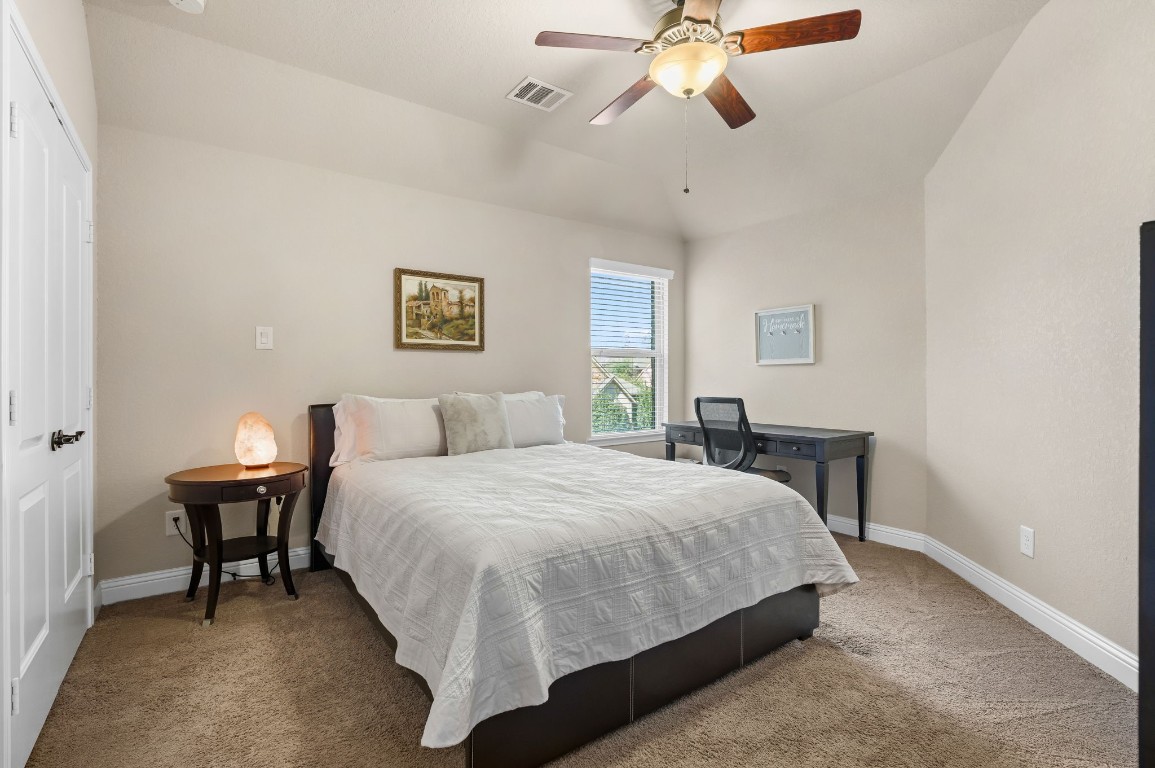 10 Waterfall Way The Woodlands, TX 77375 - Photo 36 of 45 a bedroom with a bed and a chandelier