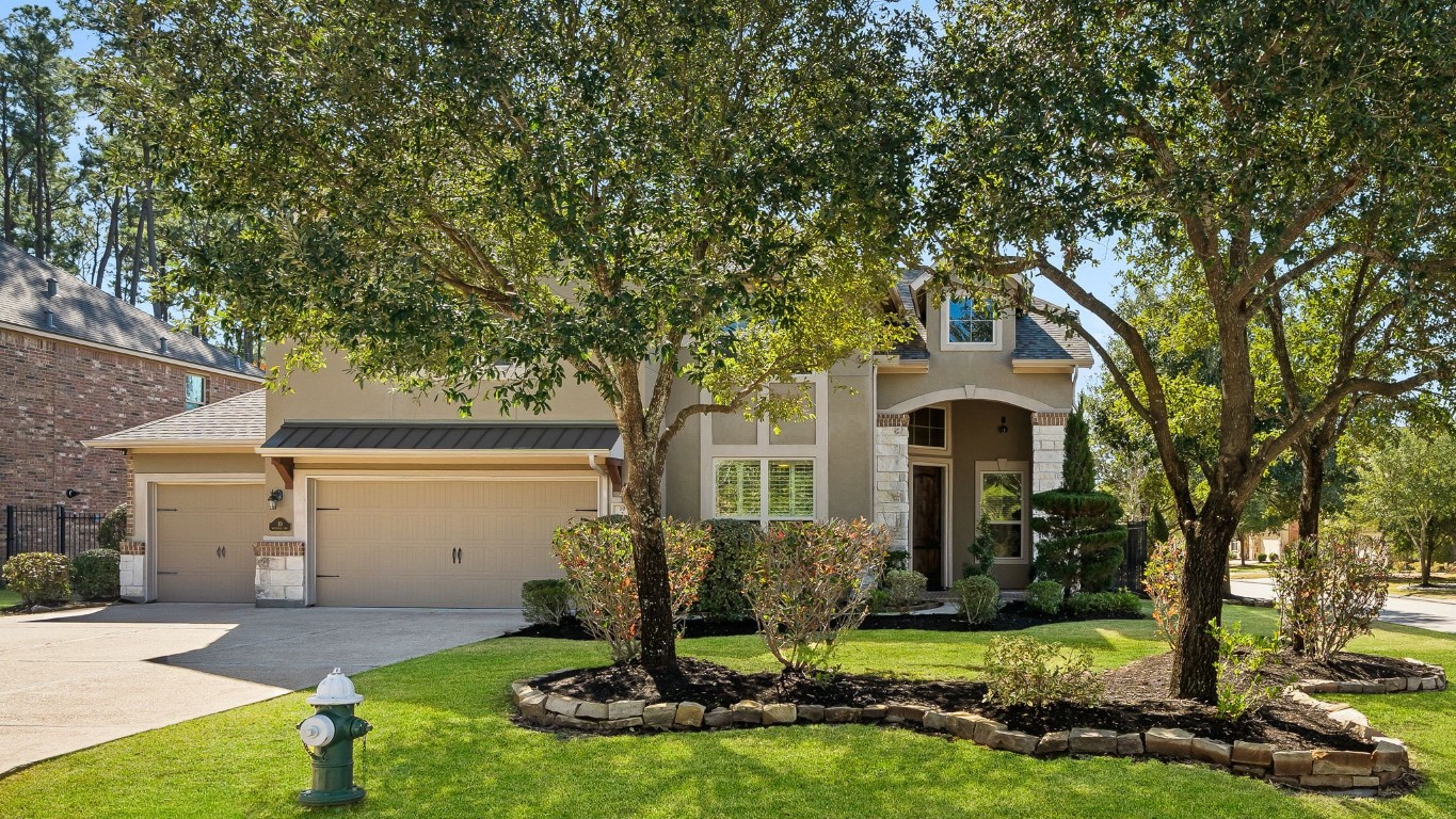 10 Waterfall Way The Woodlands, TX 77375 - Photo 4 of 45 a front view of house with yard and green space