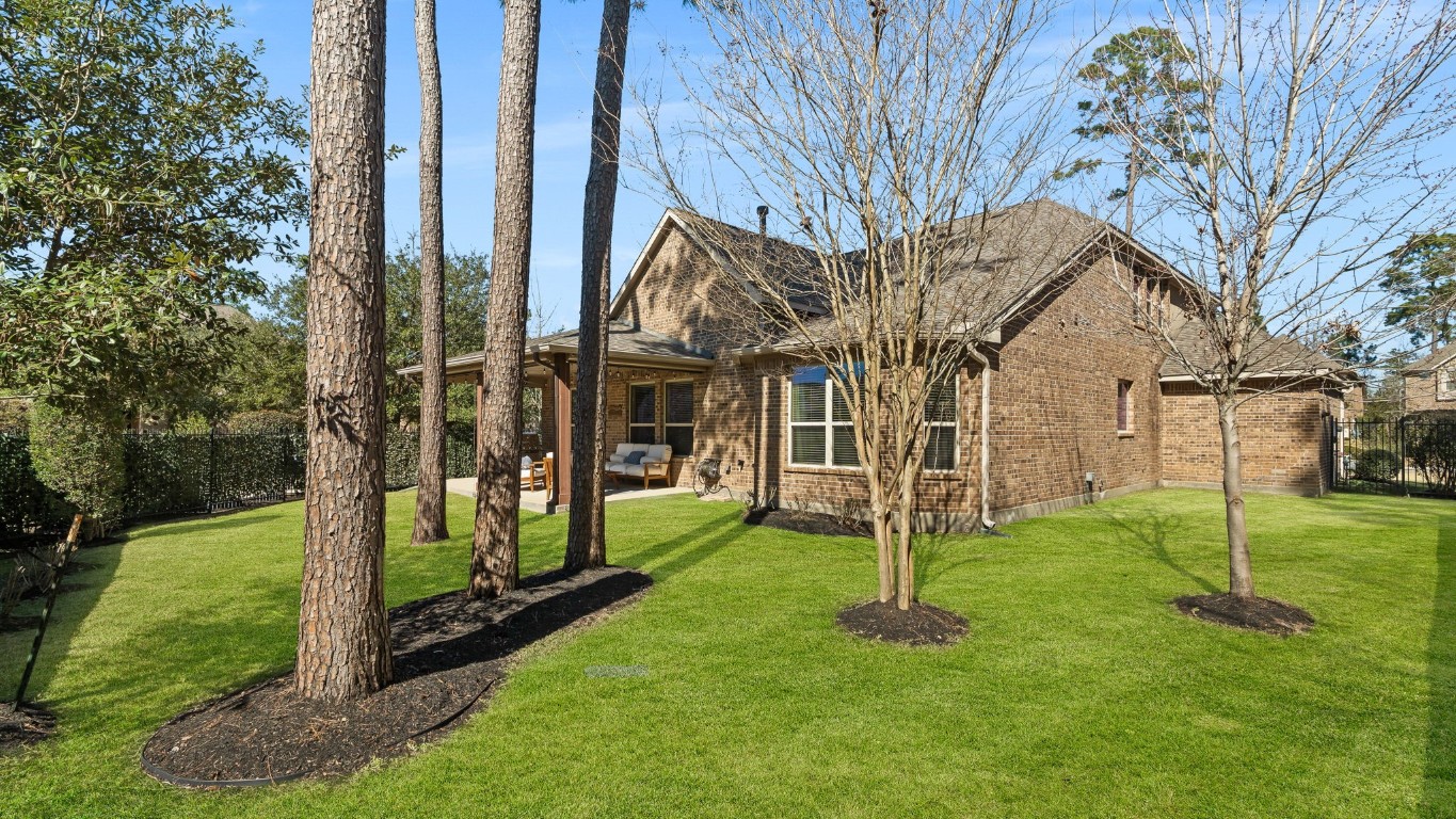 10 Waterfall Way The Woodlands, TX 77375 - Photo 42 of 45 a view of a house with backyard and a tree