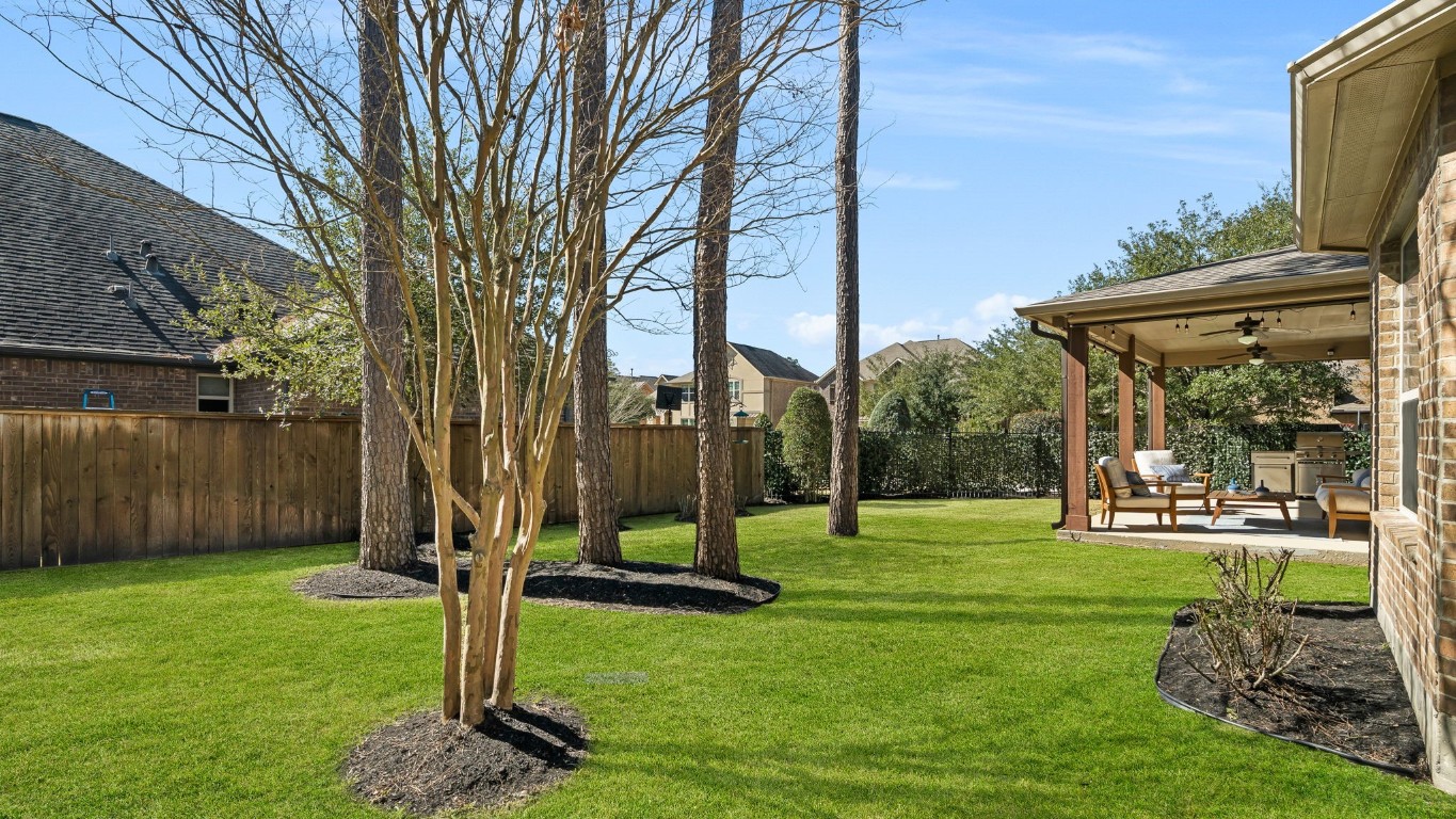 10 Waterfall Way The Woodlands, TX 77375 - Photo 43 of 45 a view of a backyard with a garden and entertaining space