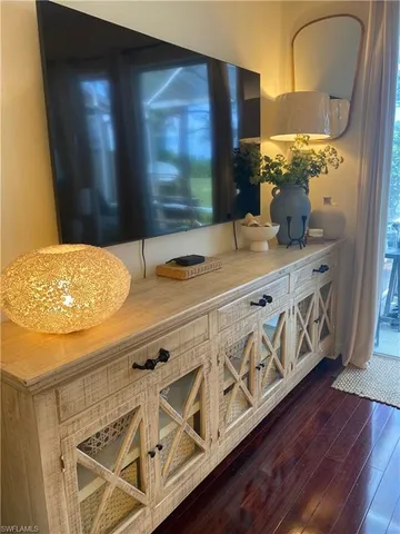 a kitchen with stainless steel appliances wooden cabinets and a wooden floor