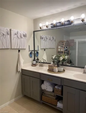 a bathroom with a sink double vanity and a mirror