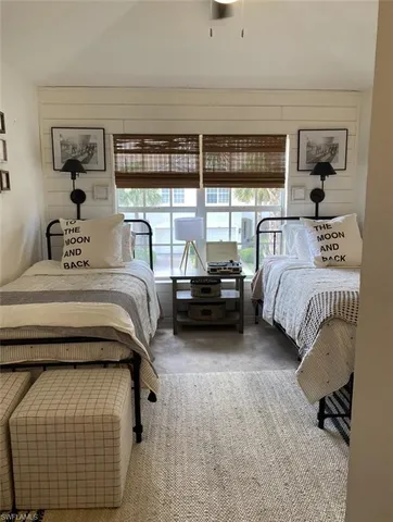 a bedroom with a bed and a night stand