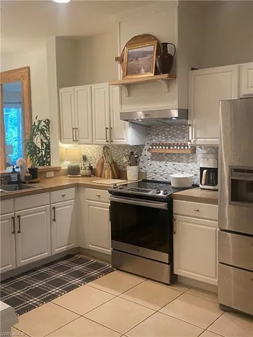 a kitchen with a stove sink and refrigerator