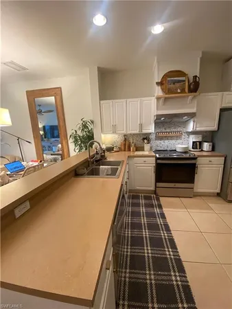 a kitchen with granite countertop a stove and a sink