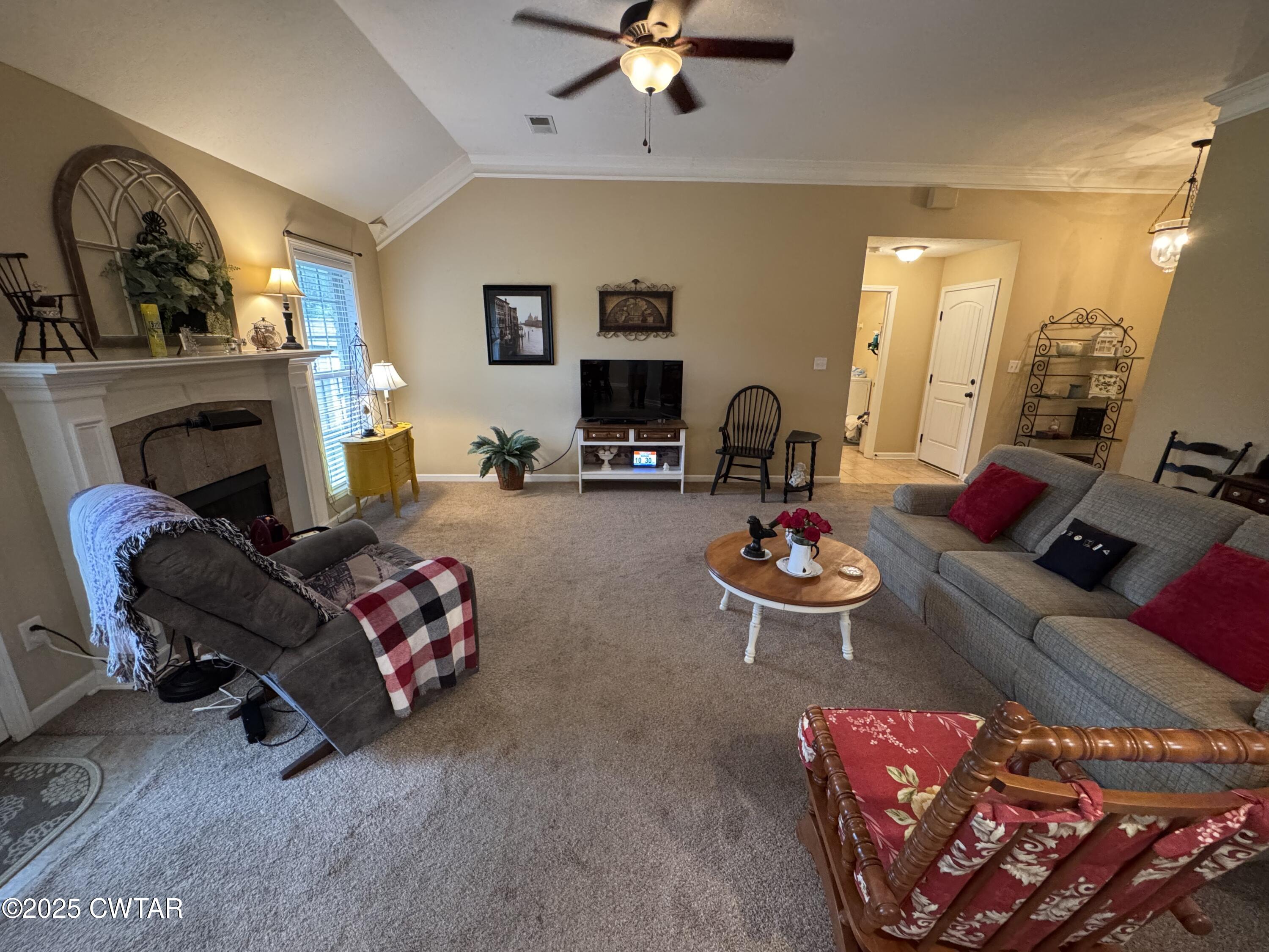 5111 Rolling Meadow Milan, TN 38358 - Photo 14 of 36 a living room with furniture a rug and a fireplace