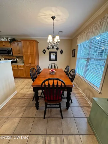a bedroom with a bed dresser and a window