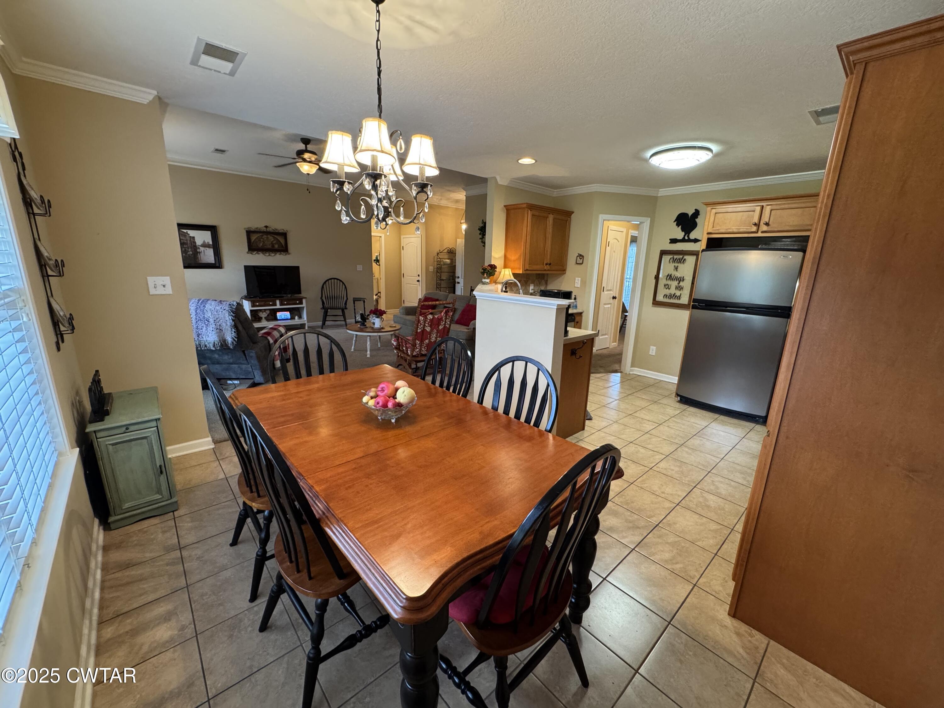5111 Rolling Meadow Milan, TN 38358 - Photo 16 of 36 a view of a dining room with furniture and a chandelier