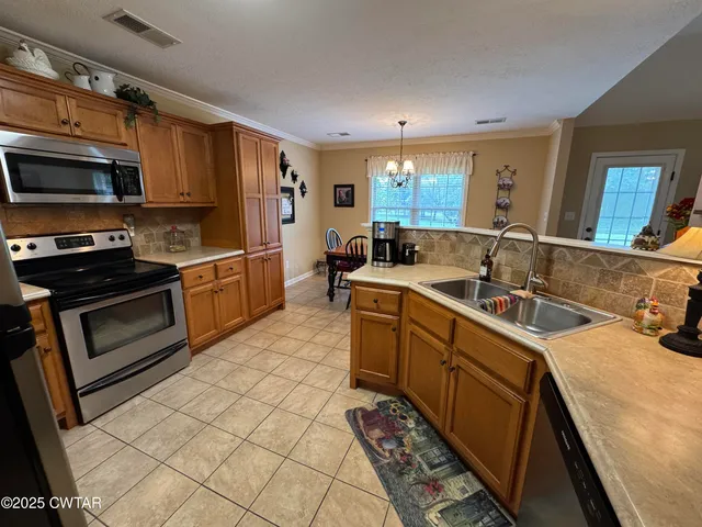 a bed room with a bed and a chandelier