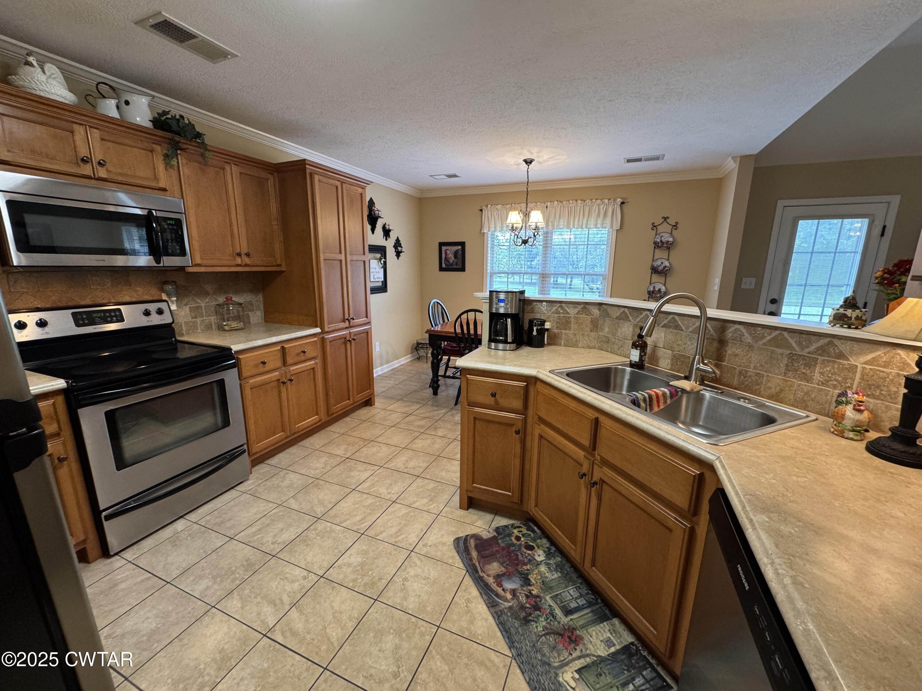 5111 Rolling Meadow Milan, TN 38358 - Photo 17 of 36 a kitchen with a sink stove and microwave