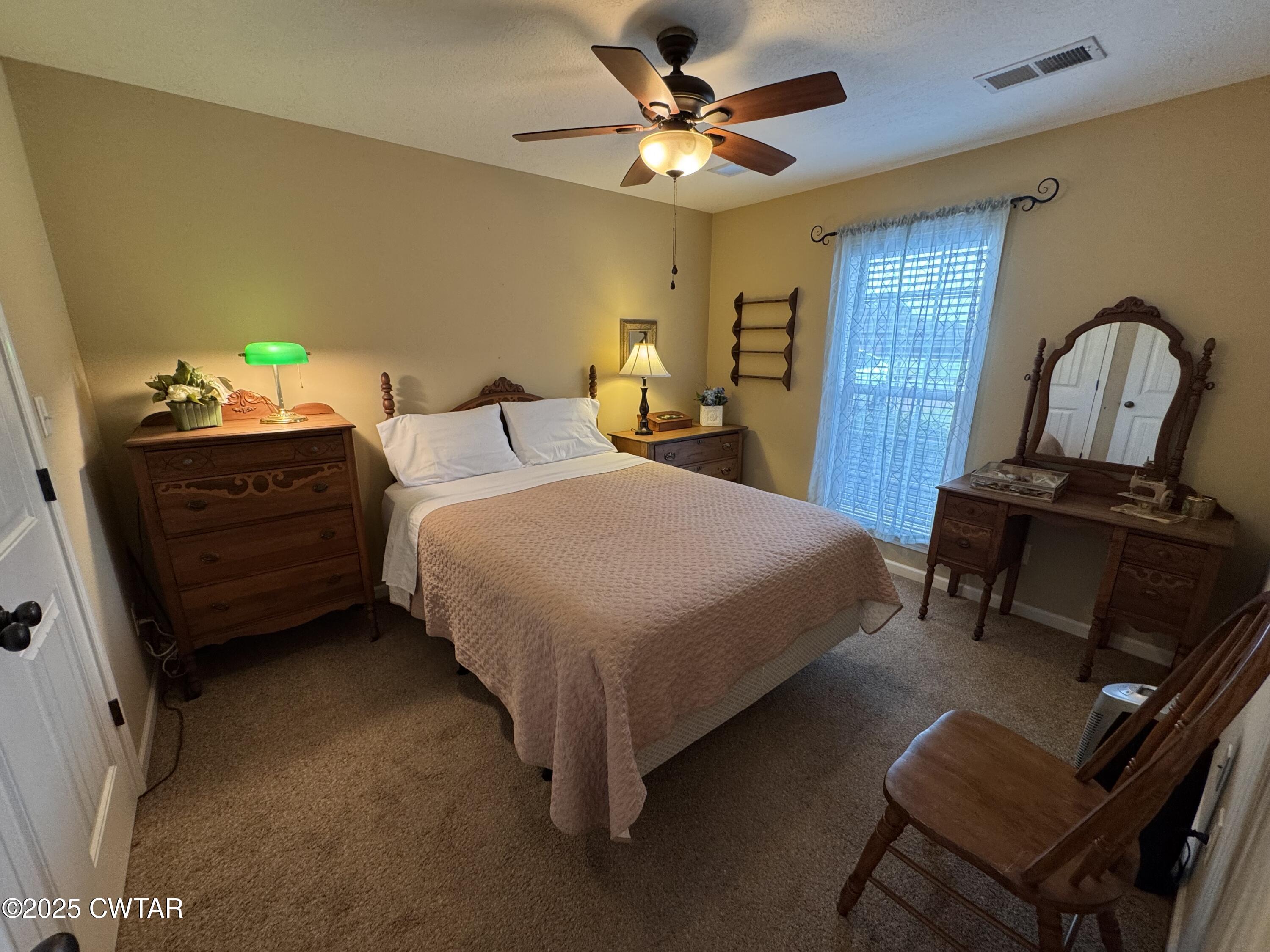 5111 Rolling Meadow Milan, TN 38358 - Photo 21 of 36 a bedroom with a bed dresser and a window