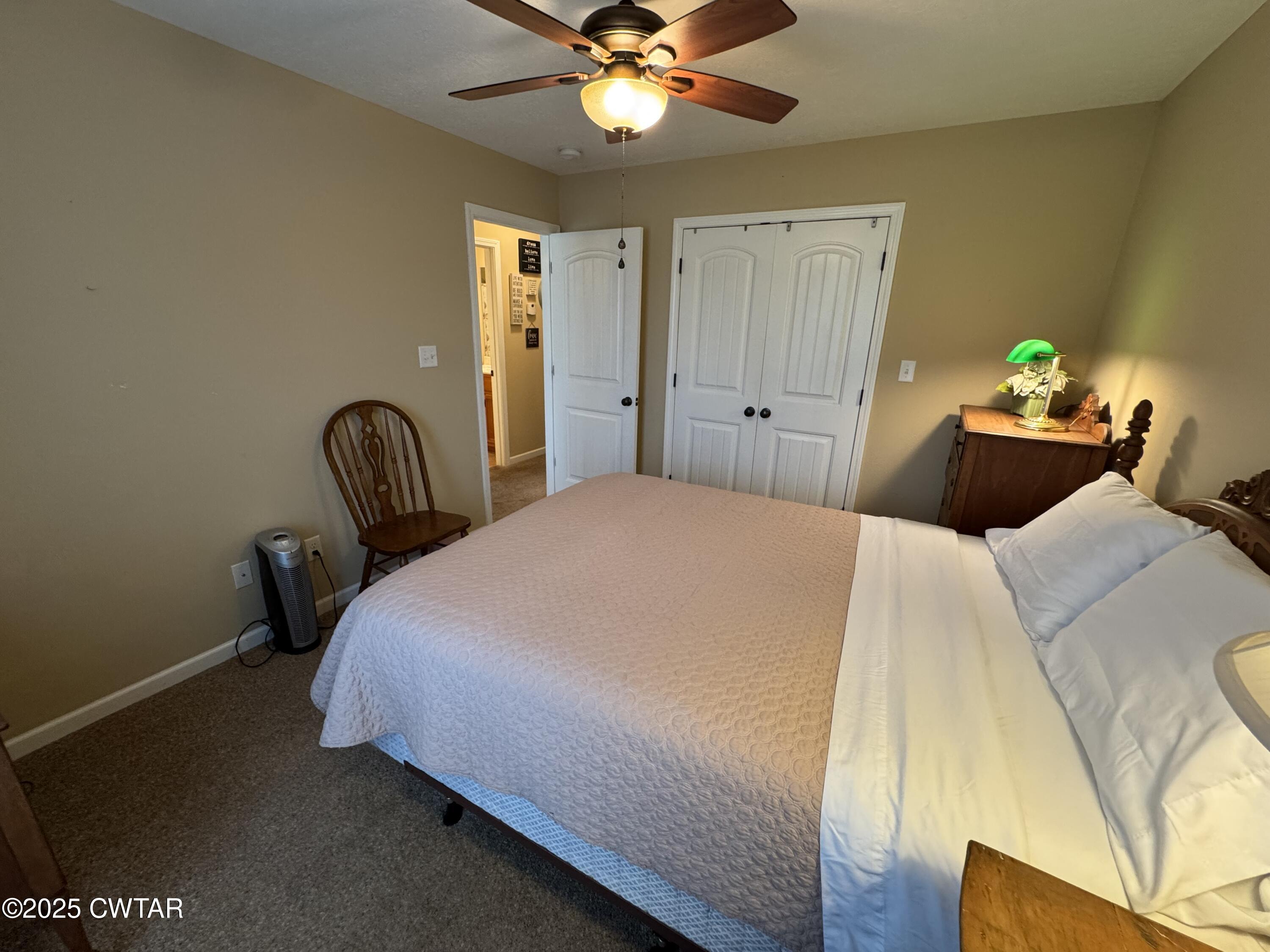 5111 Rolling Meadow Milan, TN 38358 - Photo 22 of 36 a bedroom with a bed and a chandelier