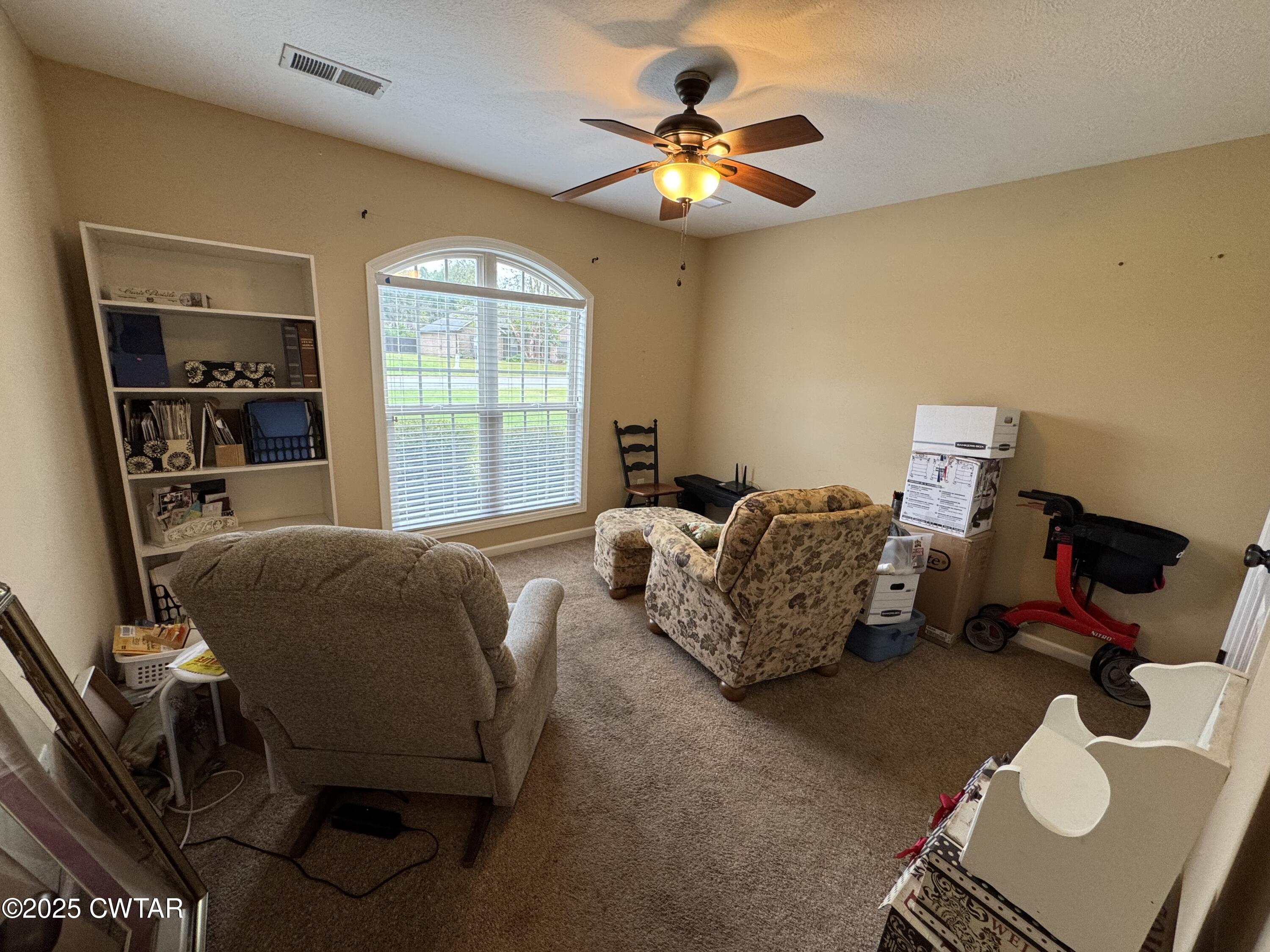 5111 Rolling Meadow Milan, TN 38358 - Photo 23 of 36 a bed room with a bed and a chandelier