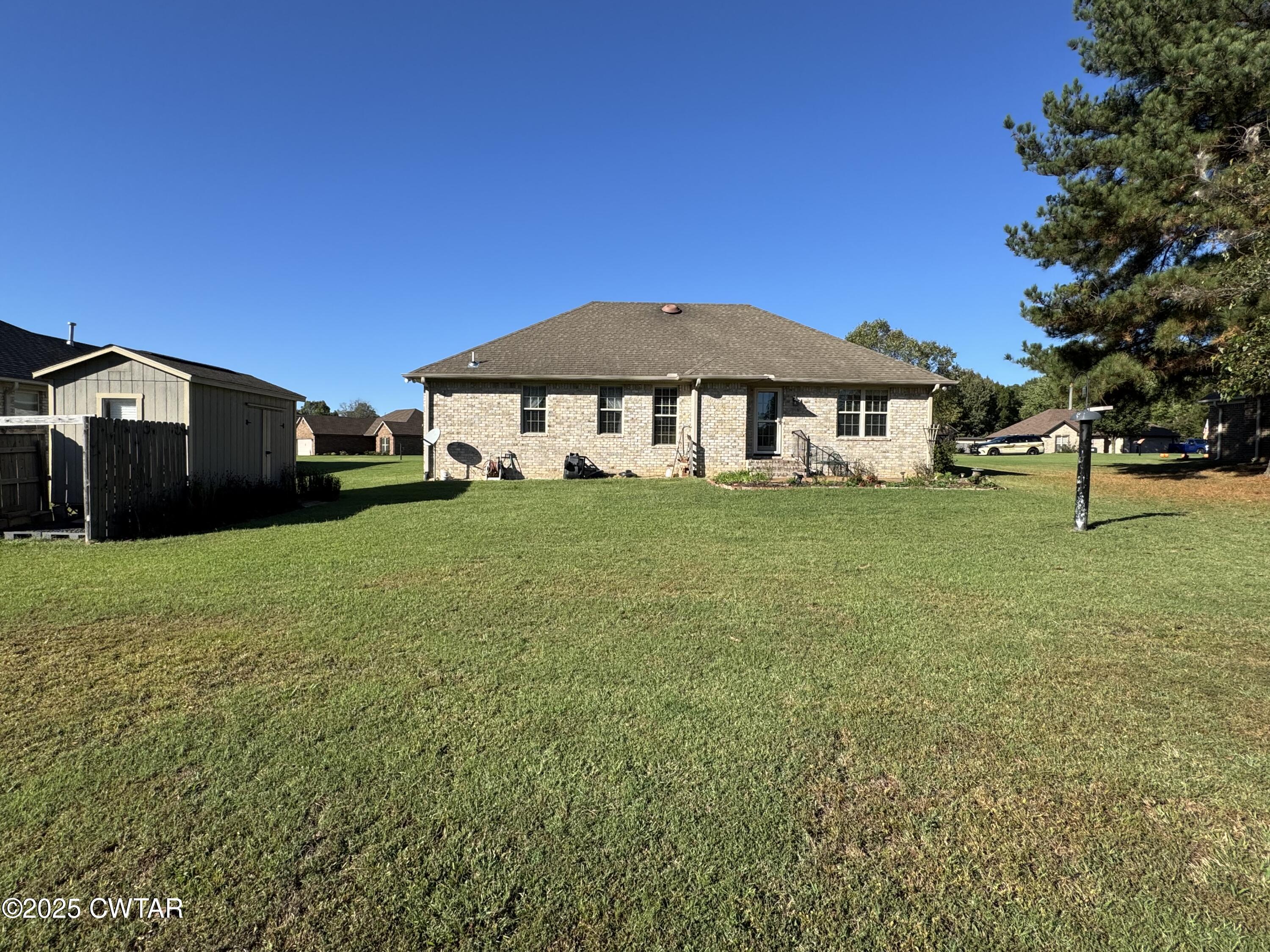 5111 Rolling Meadow Milan, TN 38358 - Photo 26 of 36 a front view of a house with a yard