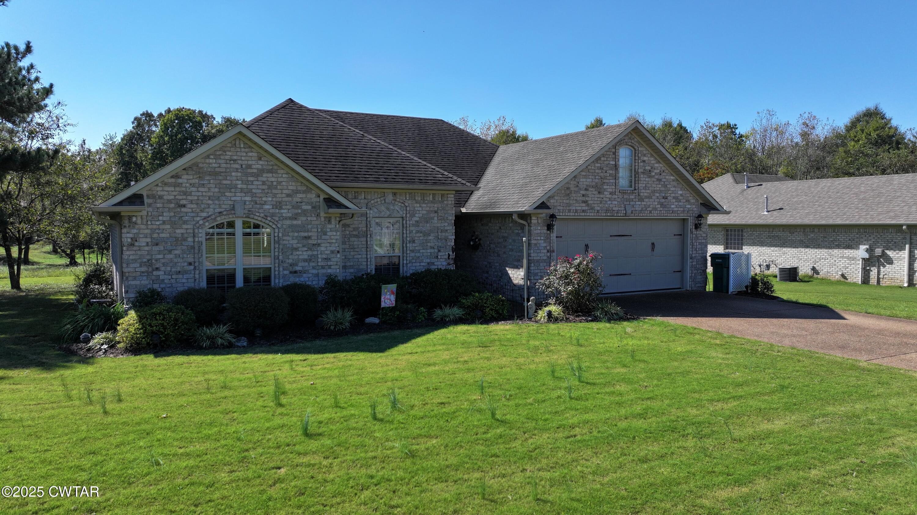 5111 Rolling Meadow Milan, TN 38358 - Photo 27 of 36 a front view of a house with a yard