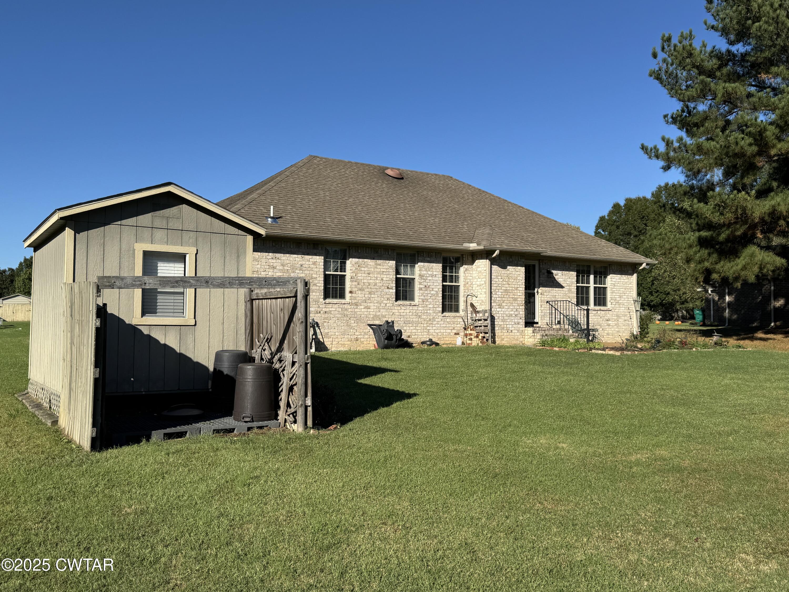 5111 Rolling Meadow Milan, TN 38358 - Photo 32 of 36 a front view of a house with a garden