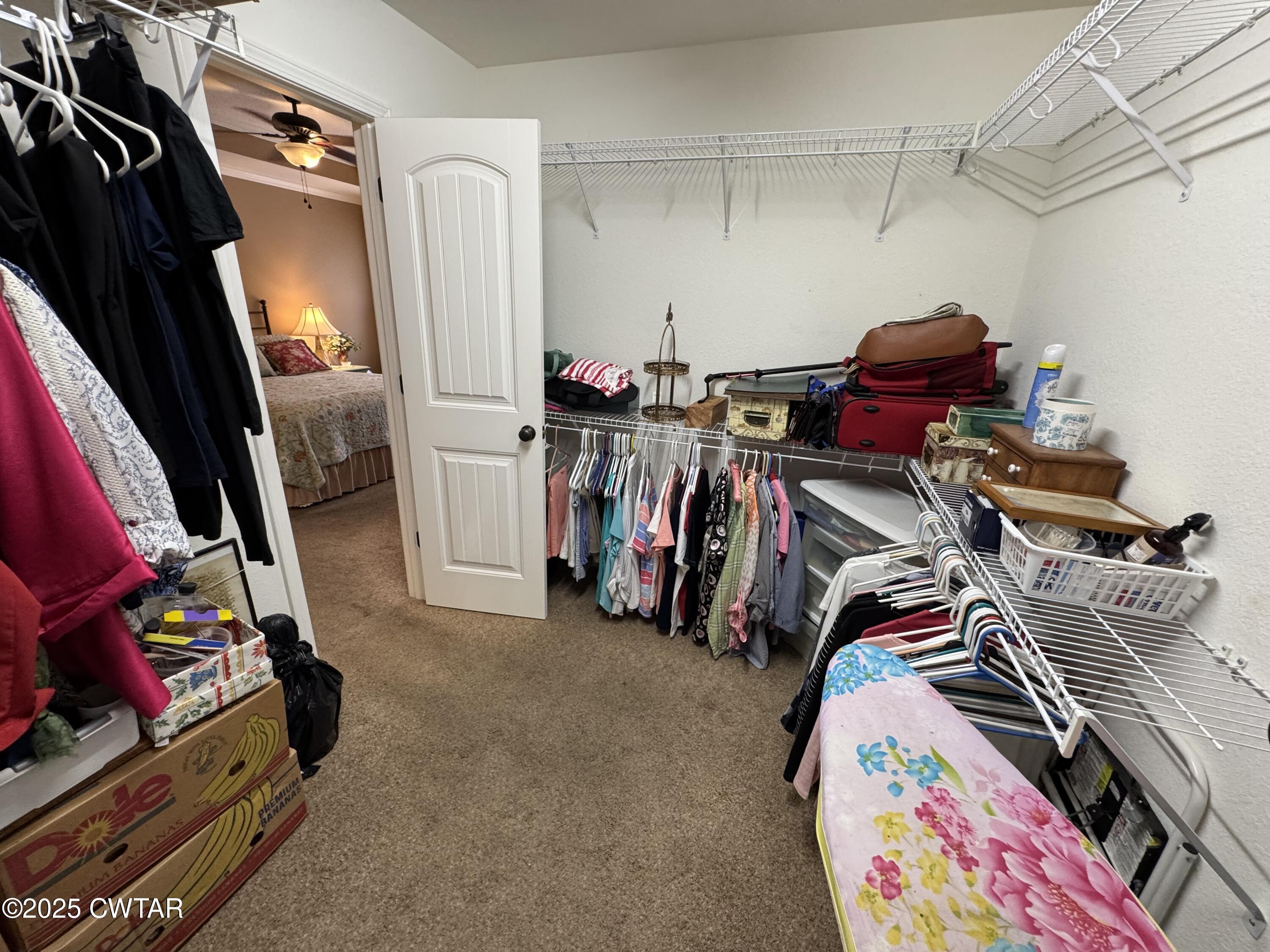 5111 Rolling Meadow Milan, TN 38358 - Photo 8 of 36 a view of walk in closet with clothes and shoes