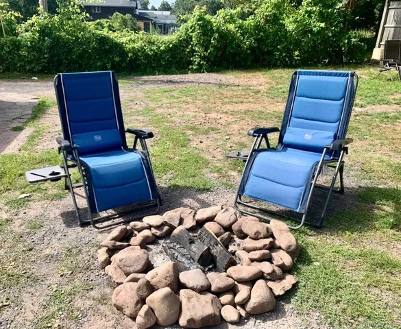 a view of a yard with chairs