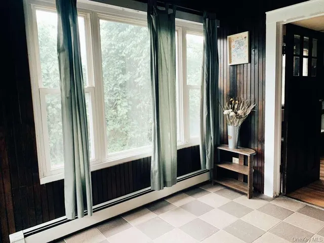 a view of an entryway with wooden floor