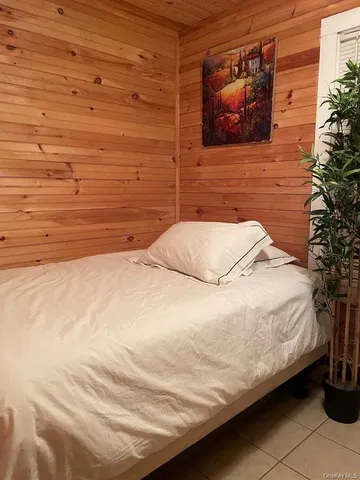 a bedroom with a bed and a potted plant