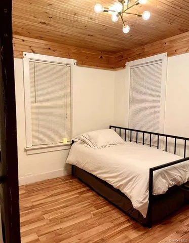 a large bed sitting in a bedroom next to a window