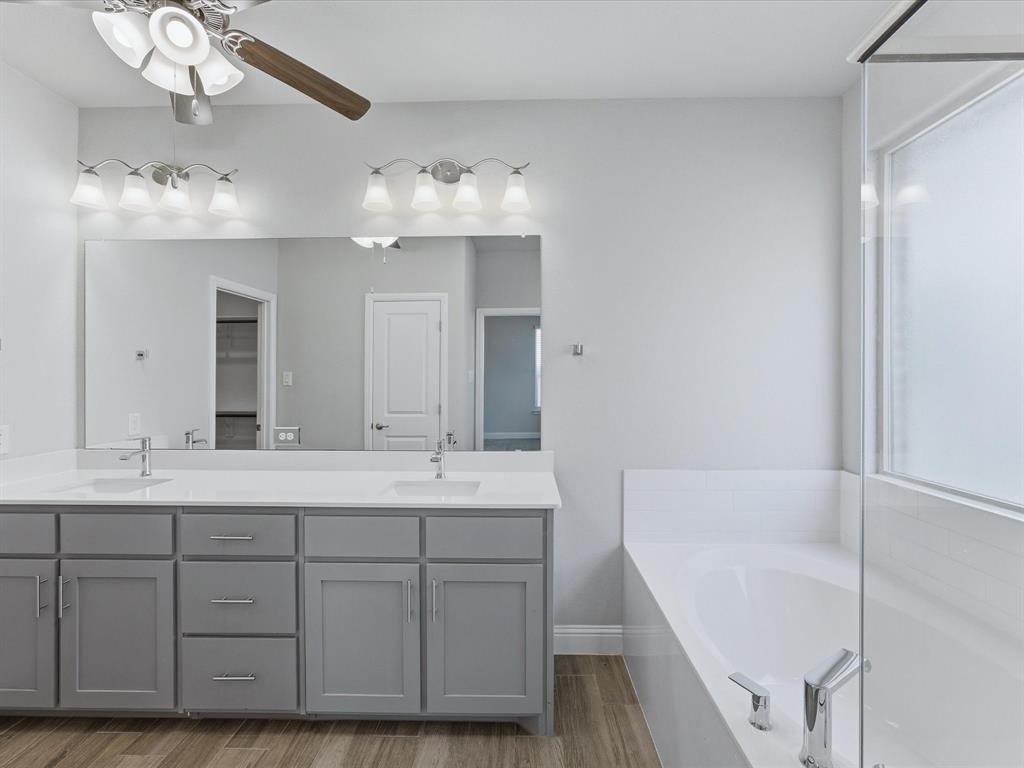 1121 Knightsbridge Road Argyle, TX 76226 - Photo 13 of 39 Primary Bathroom with Dual vanity with gray cabinetry and white countertops, featuring two undermount sinks with chrome faucets