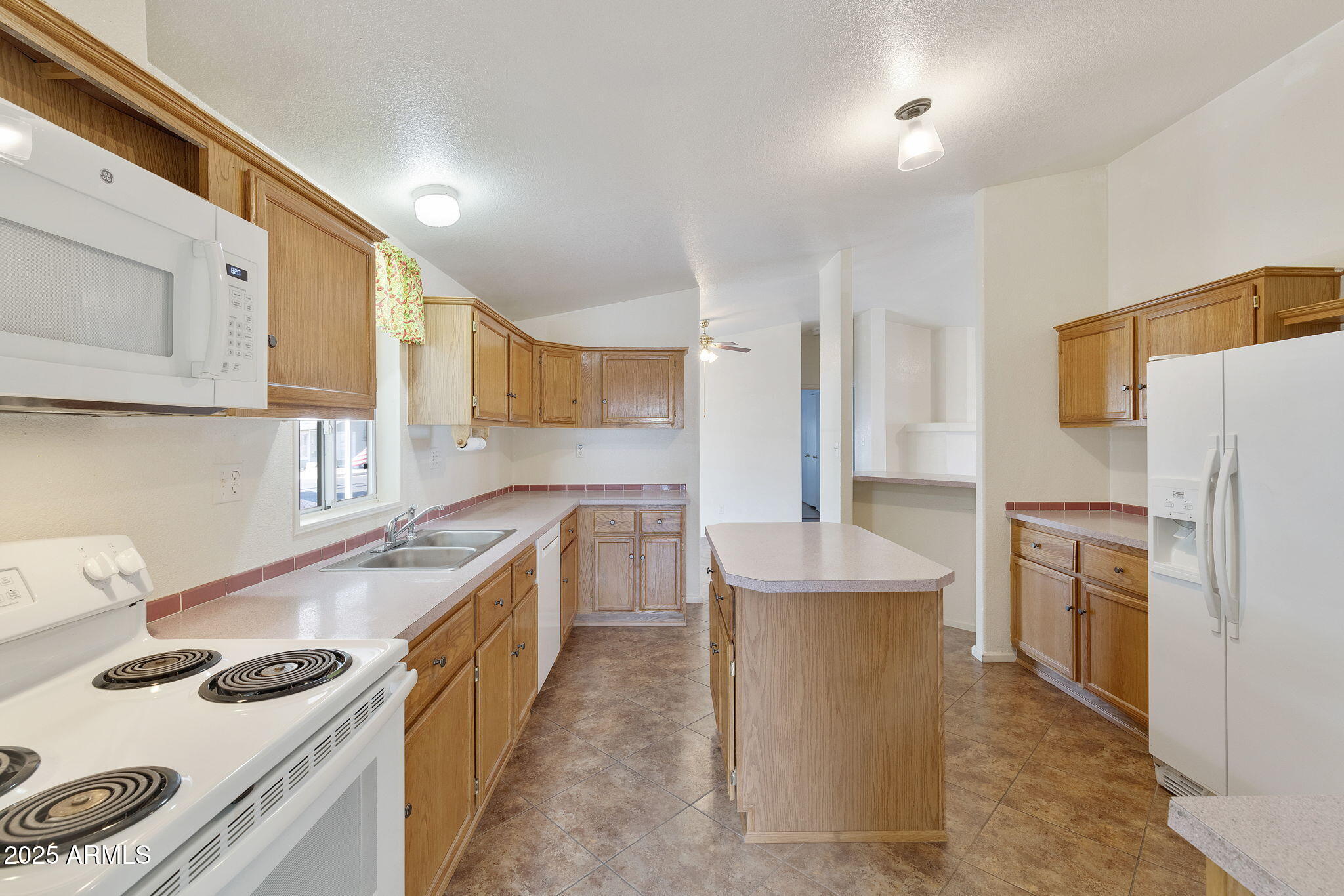 3700 South Tomahawk Road, Unit 80 Apache Junction, AZ 85119 - Photo 10 of 41 a kitchen with stainless steel appliances a sink a stove a refrigerator cabinets and a wooden floor