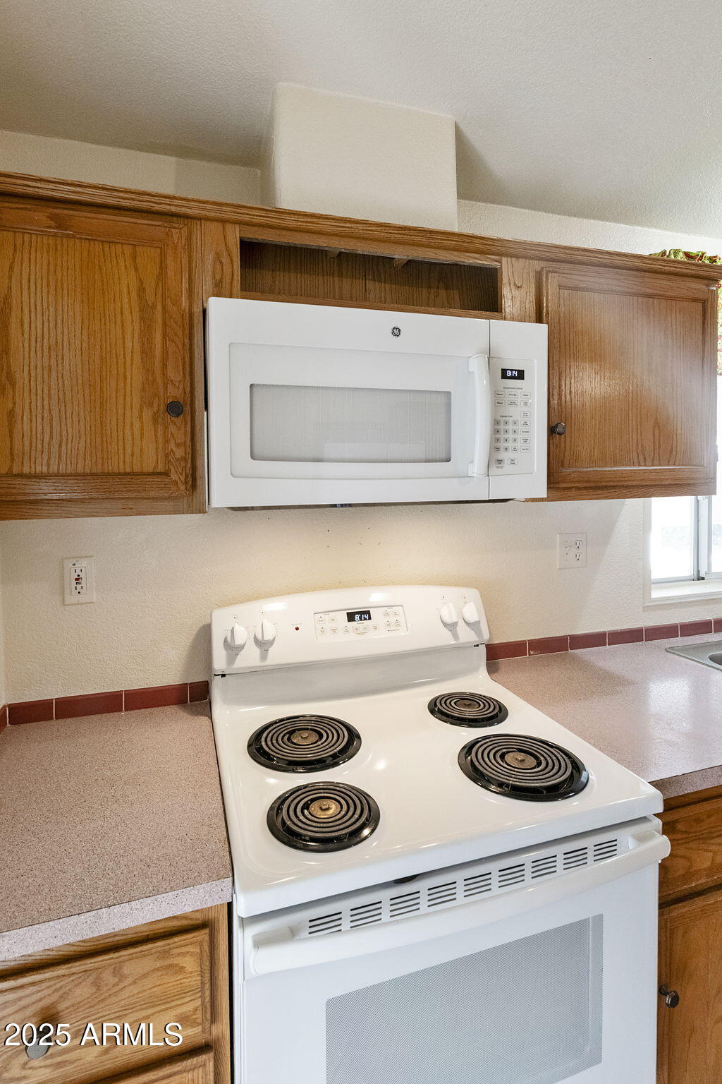 3700 South Tomahawk Road, Unit 80 Apache Junction, AZ 85119 - Photo 11 of 41 a kitchen with a stove and a microwave