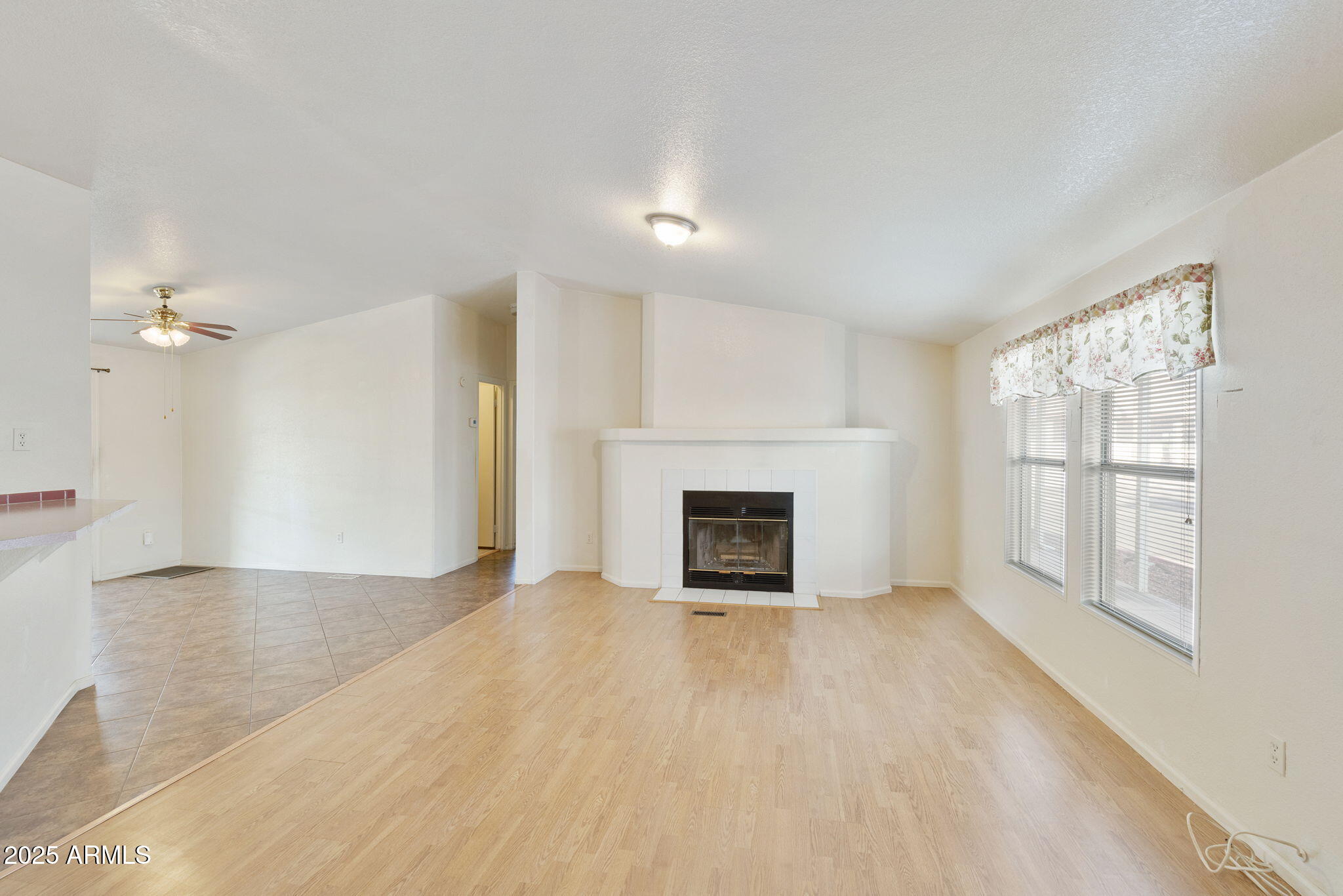 3700 South Tomahawk Road, Unit 80 Apache Junction, AZ 85119 - Photo 18 of 41 an empty room with windows and fireplace