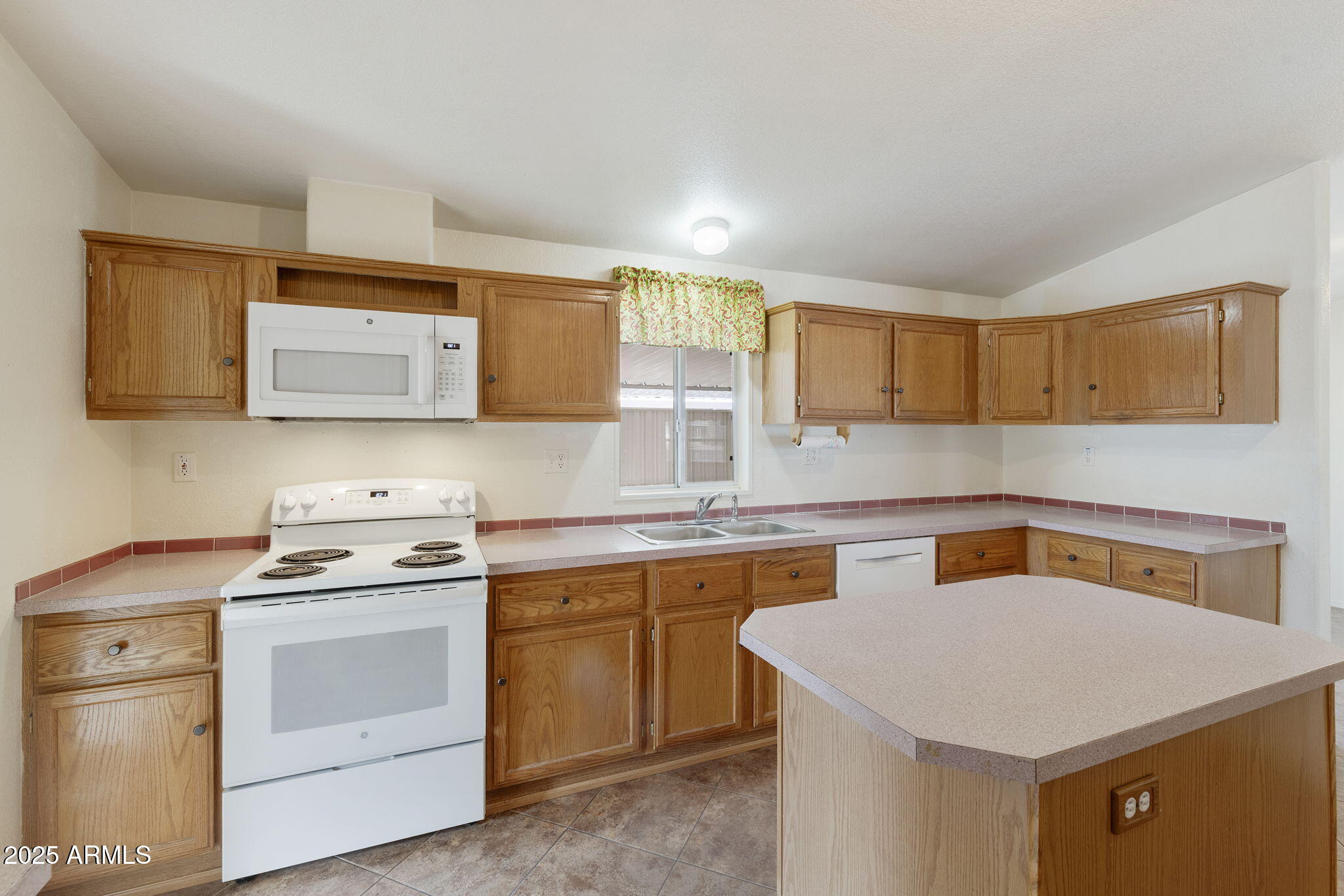 3700 South Tomahawk Road, Unit 80 Apache Junction, AZ 85119 - Photo 26 of 41 a kitchen with a stove a sink and a microwave
