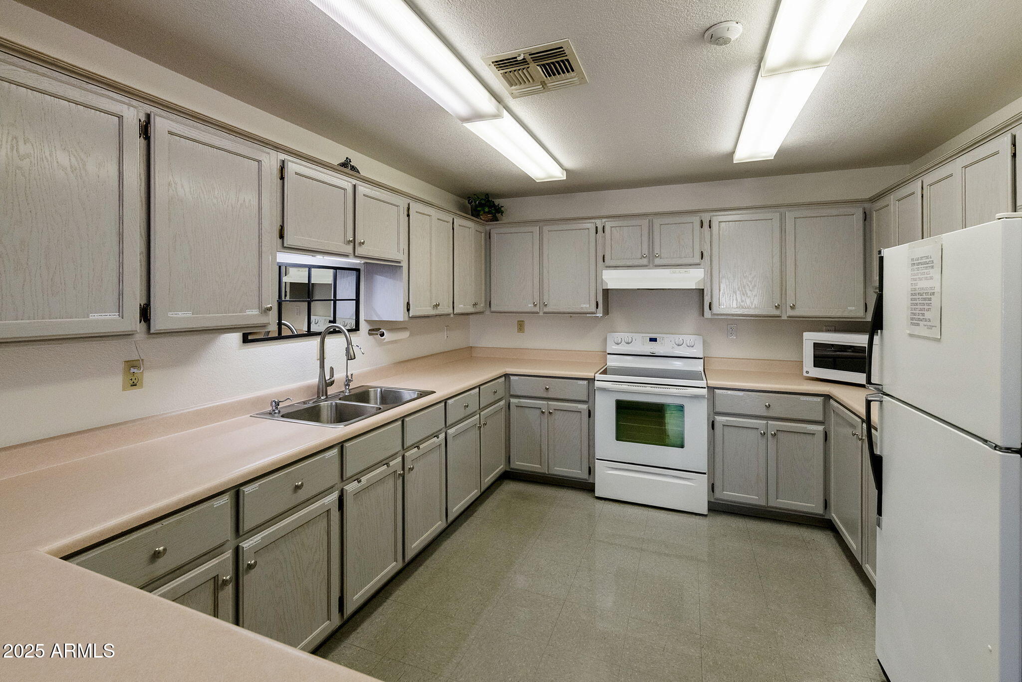 3700 South Tomahawk Road, Unit 80 Apache Junction, AZ 85119 - Photo 33 of 41 a kitchen with appliances cabinets and a sink