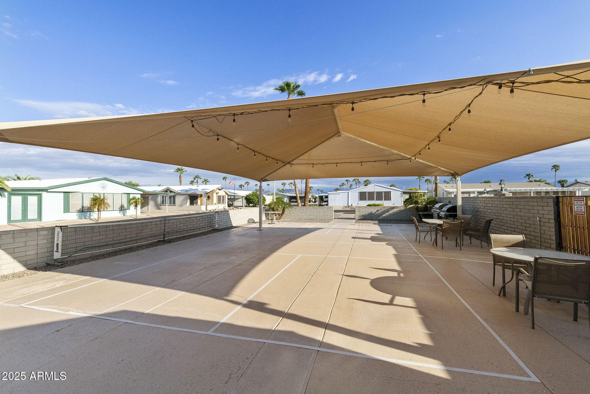 3700 South Tomahawk Road, Unit 80 Apache Junction, AZ 85119 - Photo 35 of 41 a swimming pool with outdoor seating and yard