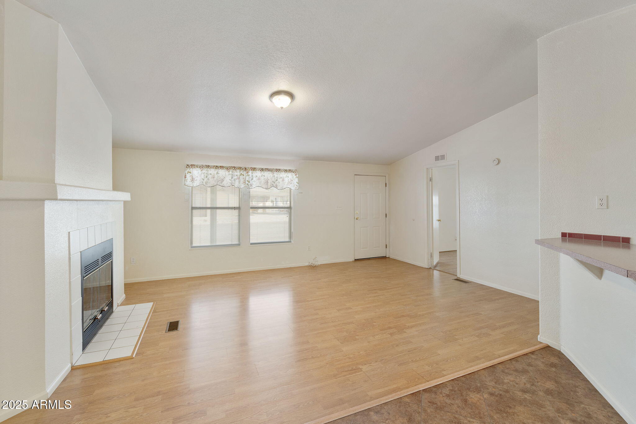 3700 South Tomahawk Road, Unit 80 Apache Junction, AZ 85119 - Photo 9 of 41 an empty room with windows and fireplace