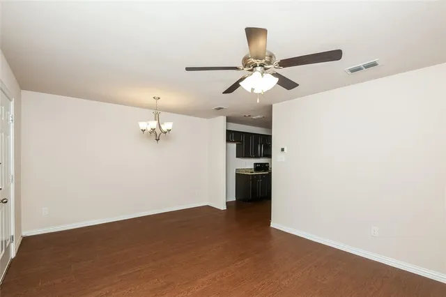 a view of a room with a ceiling fan and entryway