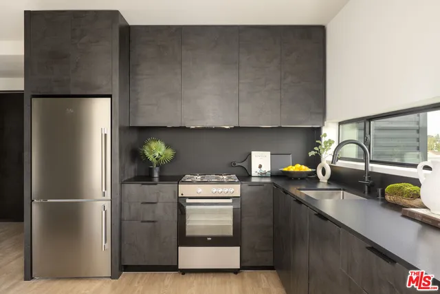 a kitchen with a refrigerator and a sink