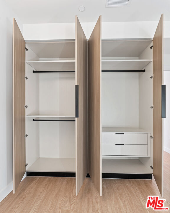 3667 Keystone Avenue, Unit 526 Los Angeles, CA 90034 - Photo 9 of 30 a view of walk in closet with empty racks