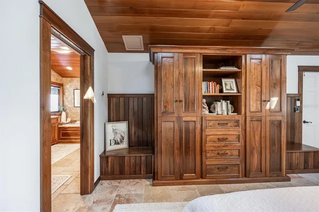 a bedroom with furniture and a book shelf