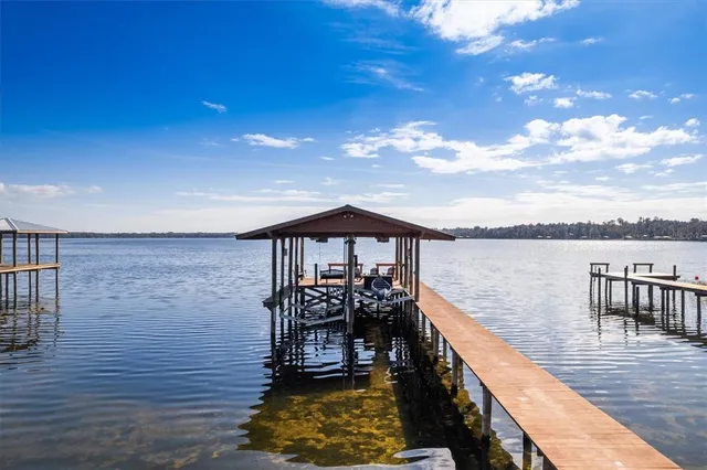 a view of a roof deck with two couches and wooden floor