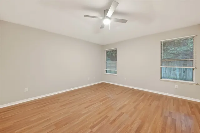 wooden floor in an empty room with a window
