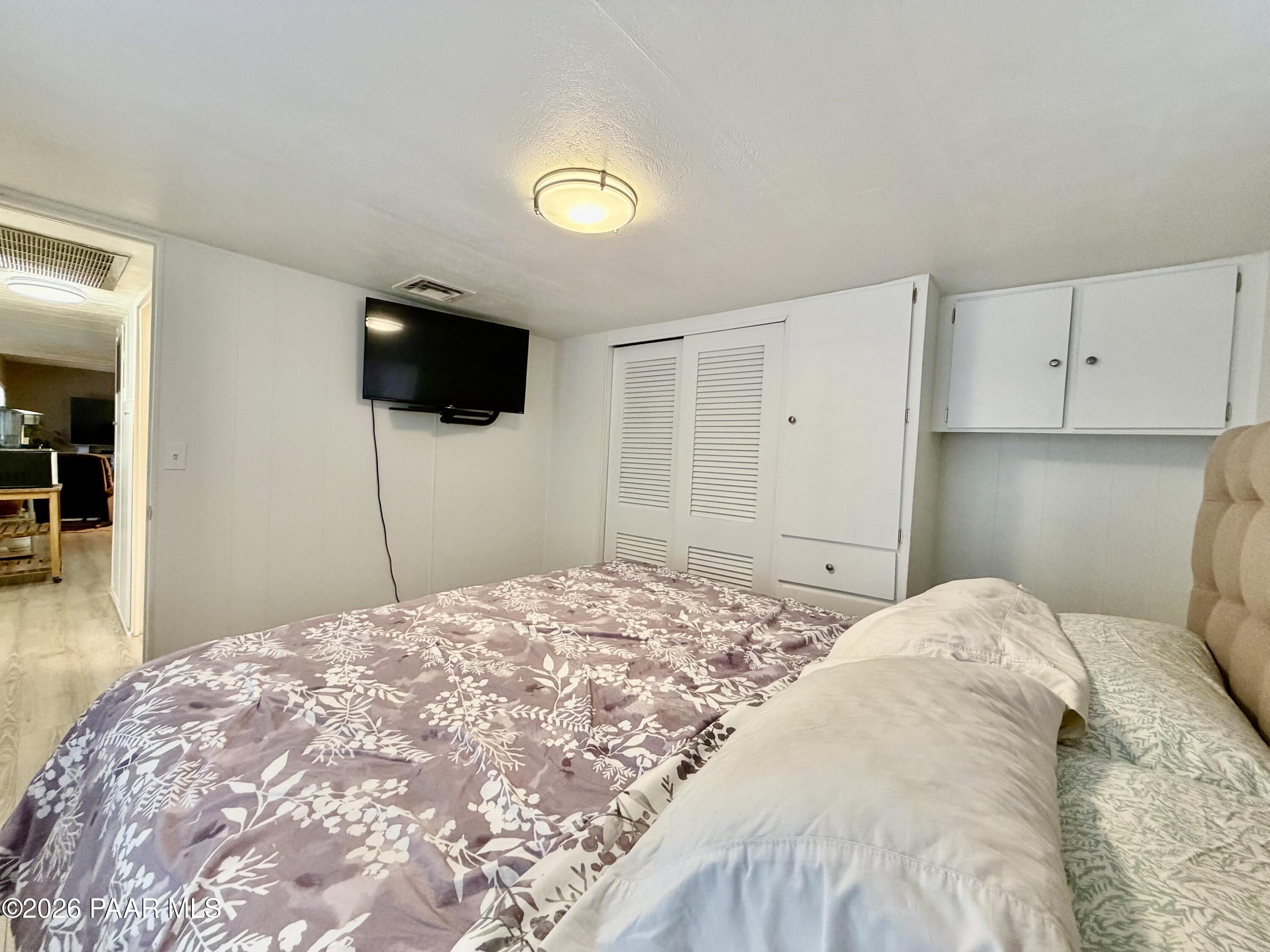 837 Division Street, Unit 32 Prescott, AZ 86301 - Photo 13 of 21 a bedroom with a bed and a flat screen tv