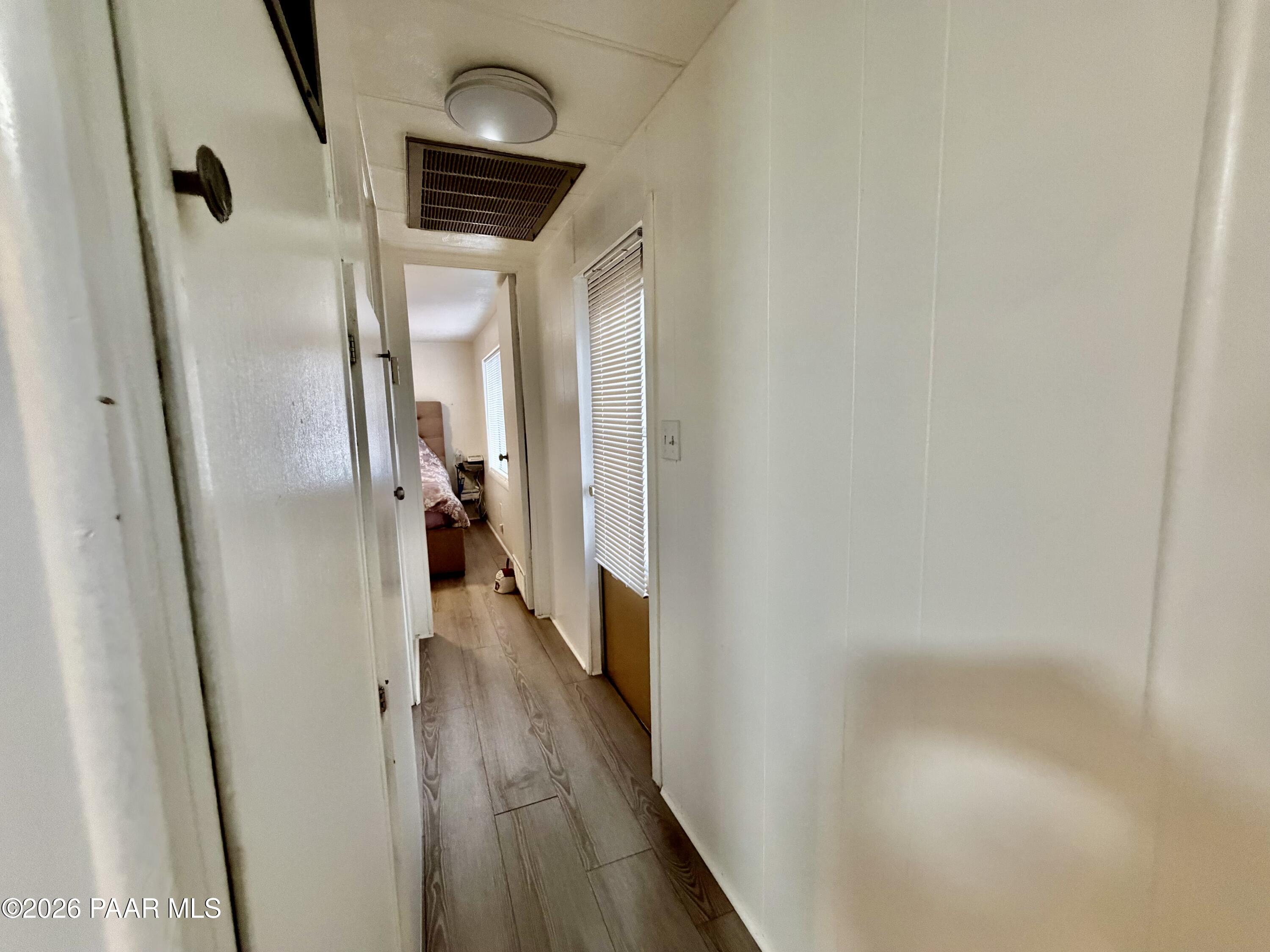 837 Division Street, Unit 32 Prescott, AZ 86301 - Photo 20 of 21 a view of a hallway with wooden floor and staircase
