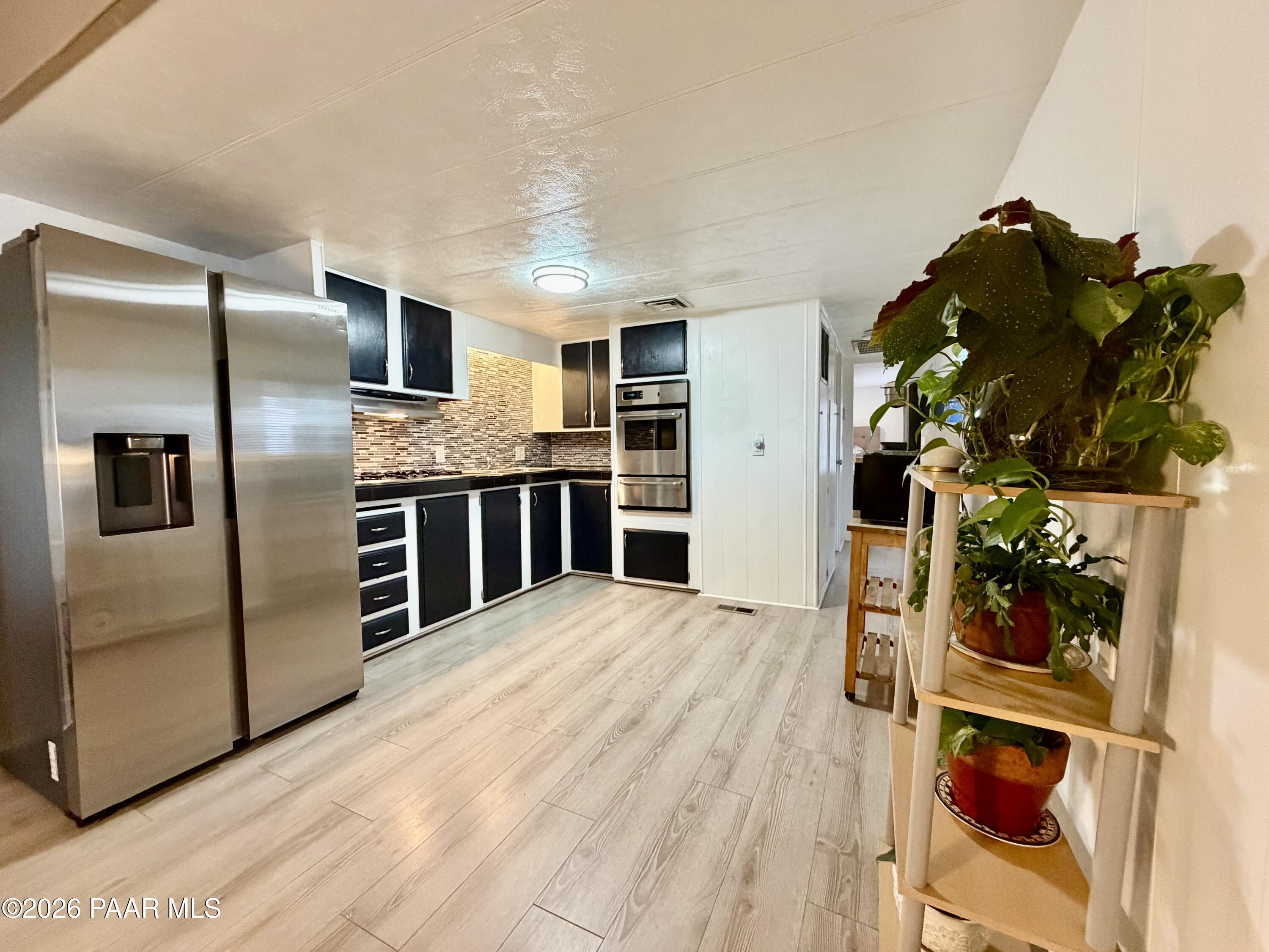 837 Division Street, Unit 32 Prescott, AZ 86301 - Photo 6 of 21 a kitchen with stainless steel appliances kitchen island a refrigerator and a stove