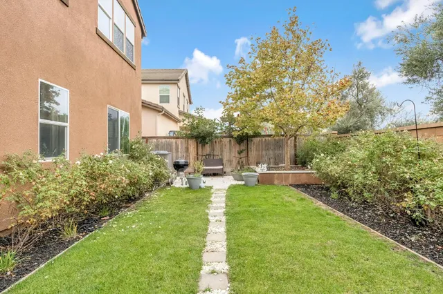 a view of a patio with couches chairs and a yard