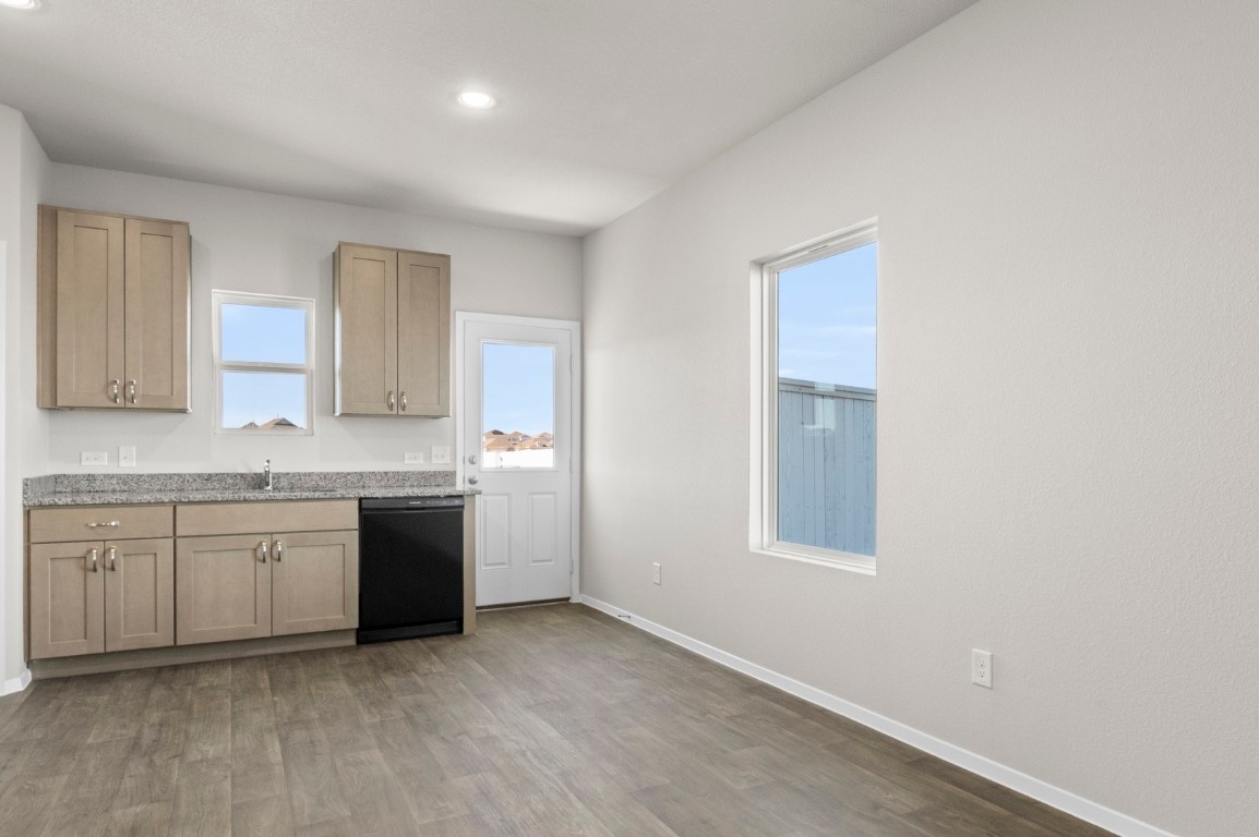 108 Summer Drive Elgin, TX 78621 - Photo 15 of 35 a kitchen with granite countertop a sink stove and cabinets