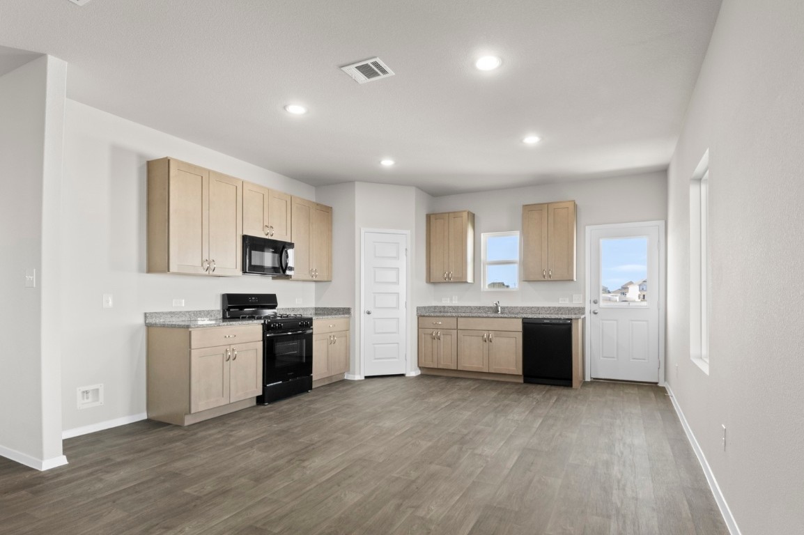 108 Summer Drive Elgin, TX 78621 - Photo 17 of 35 a large space with a large window and stainless steel appliances