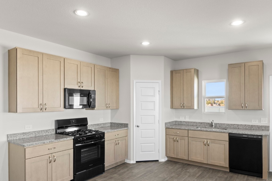 108 Summer Drive Elgin, TX 78621 - Photo 18 of 35 a kitchen with granite countertop white cabinets and stainless steel appliances